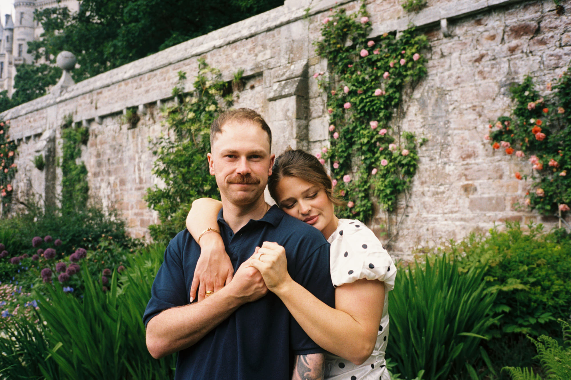 35mm film photo of a couple embracing in the garden at Dunrobin castle