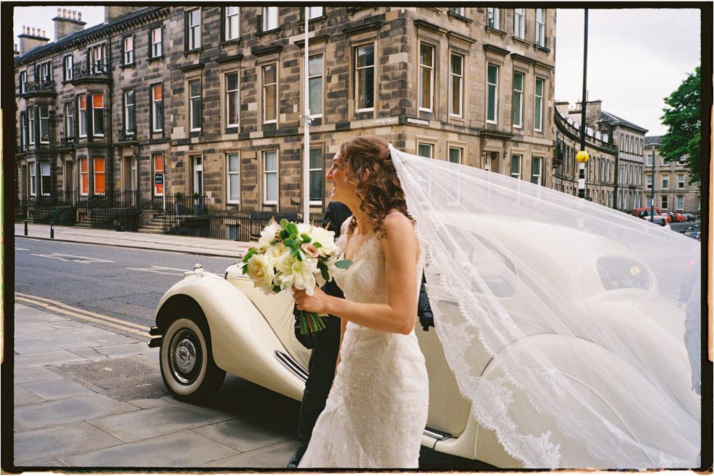 bride standing outside St Mary's Episcopal Church in Edinburgh, taken on 35mm film.