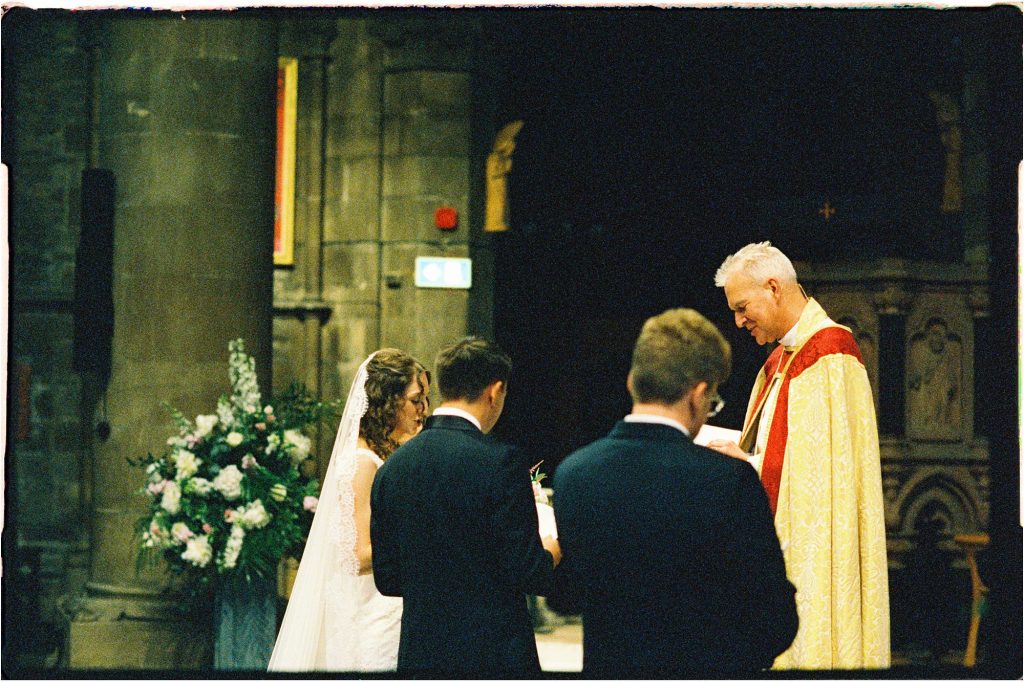 wedding ceremony in St Mary's Episcopal Church in Edinburgh, with bride, groom, bestman, and minister taken on 35mm film