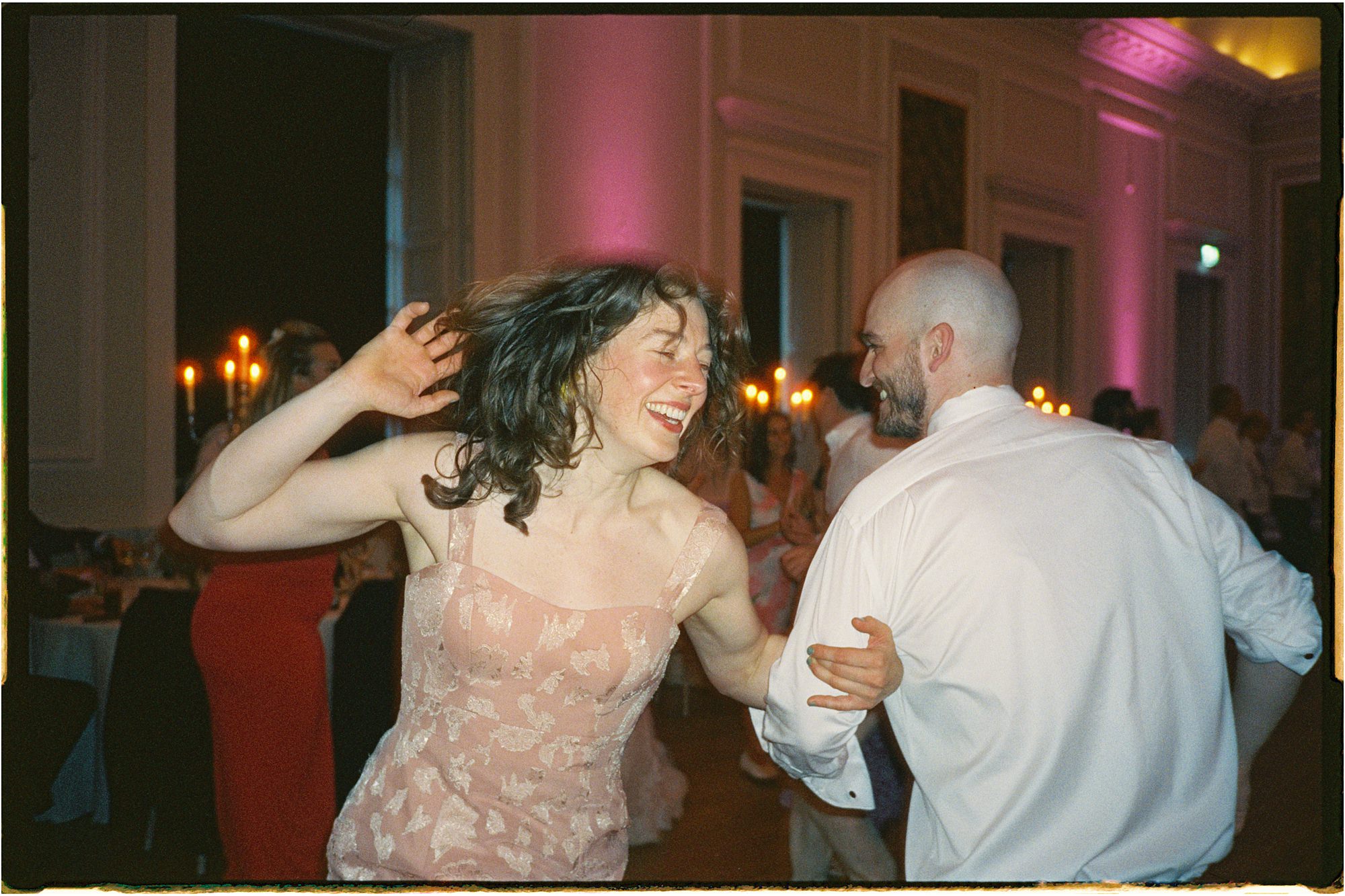 35mm film photo of guests ceilidh dancing at Hopetoun House wedding